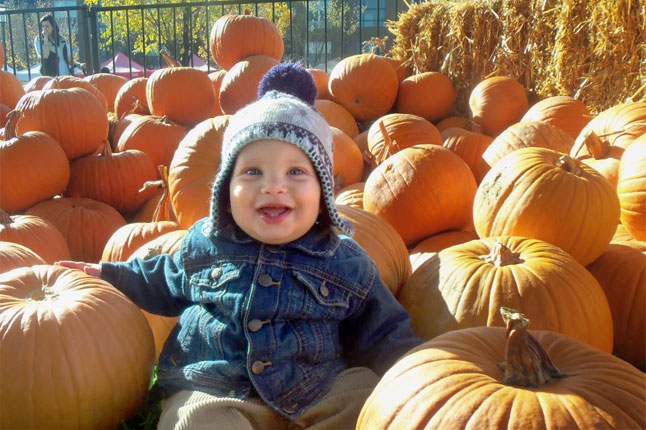 Baby in a pumpkin patch